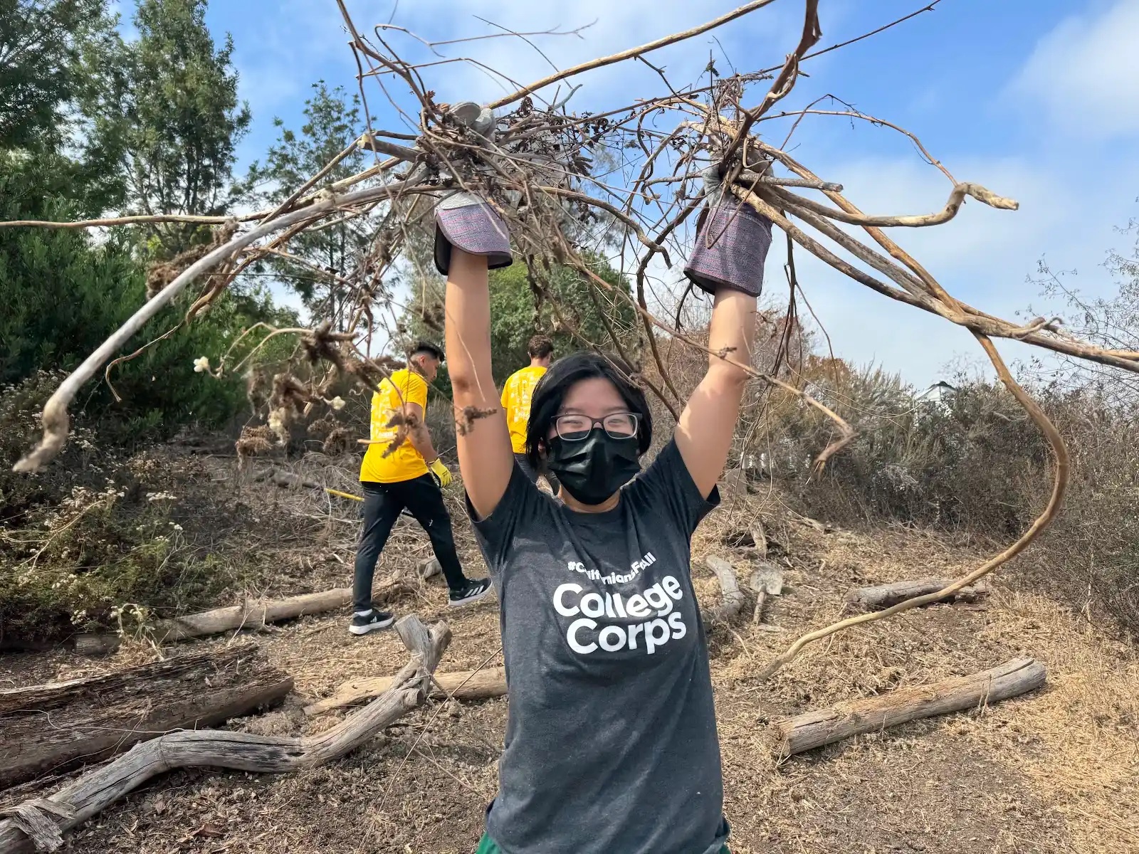 College Corps fellow Jun Sohn picking up branches during service event